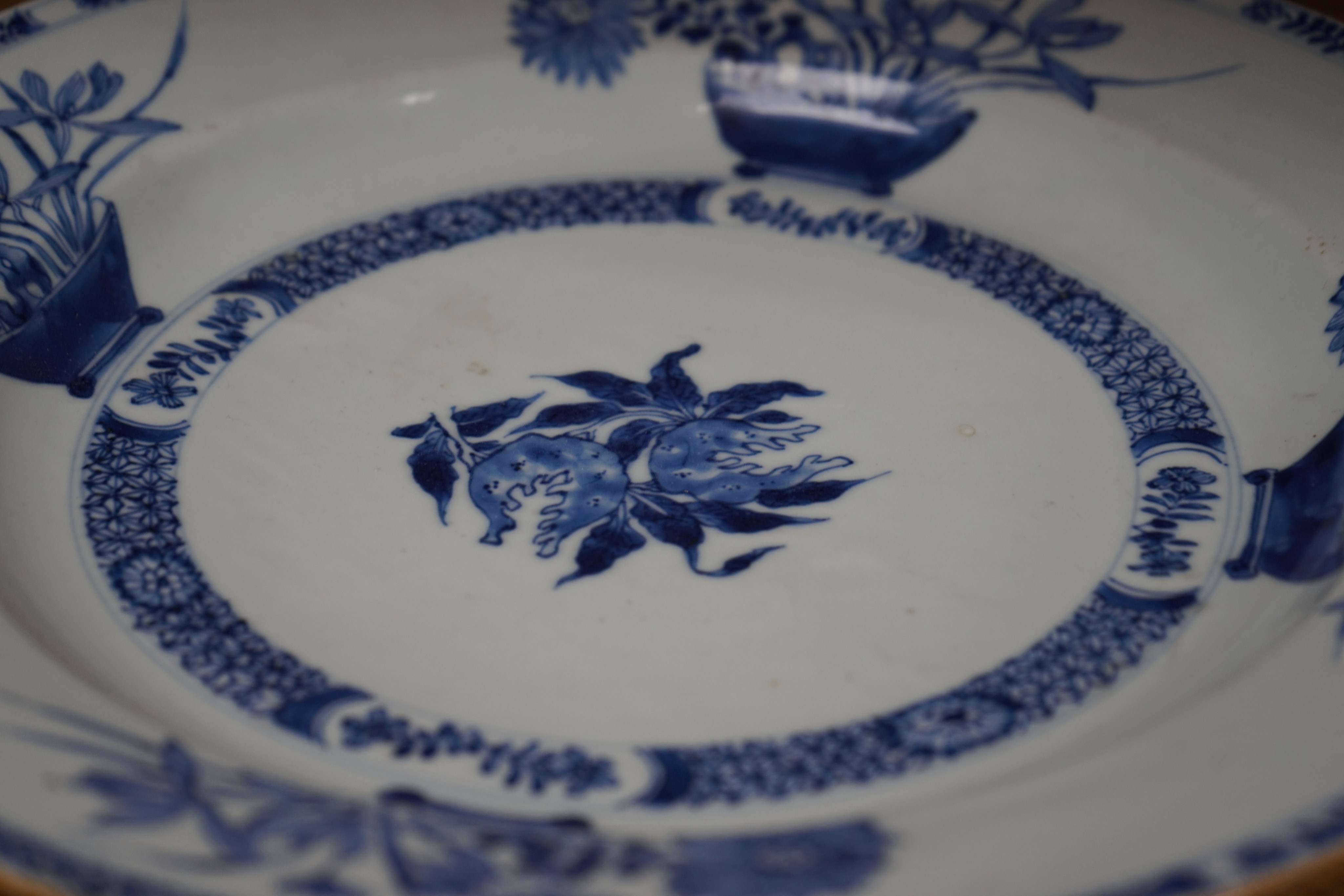 An 18th century Chinese blue and white circular dish decorated with flowering plants, Dia 32.5cm